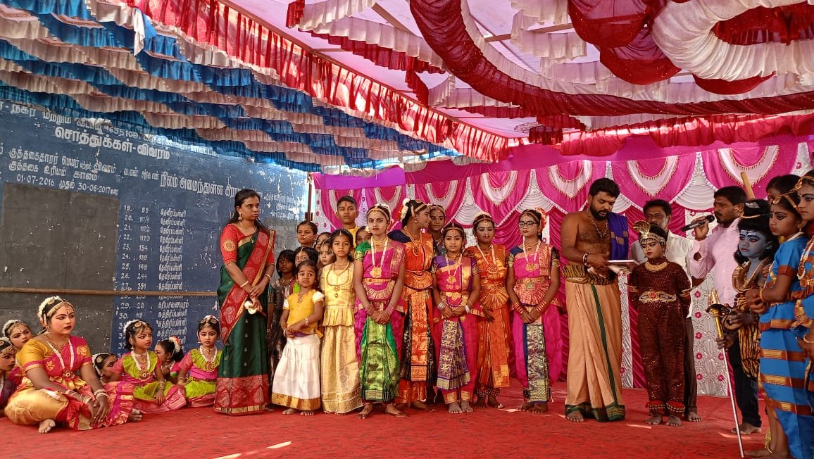 Students and performers together on a decorated stage
